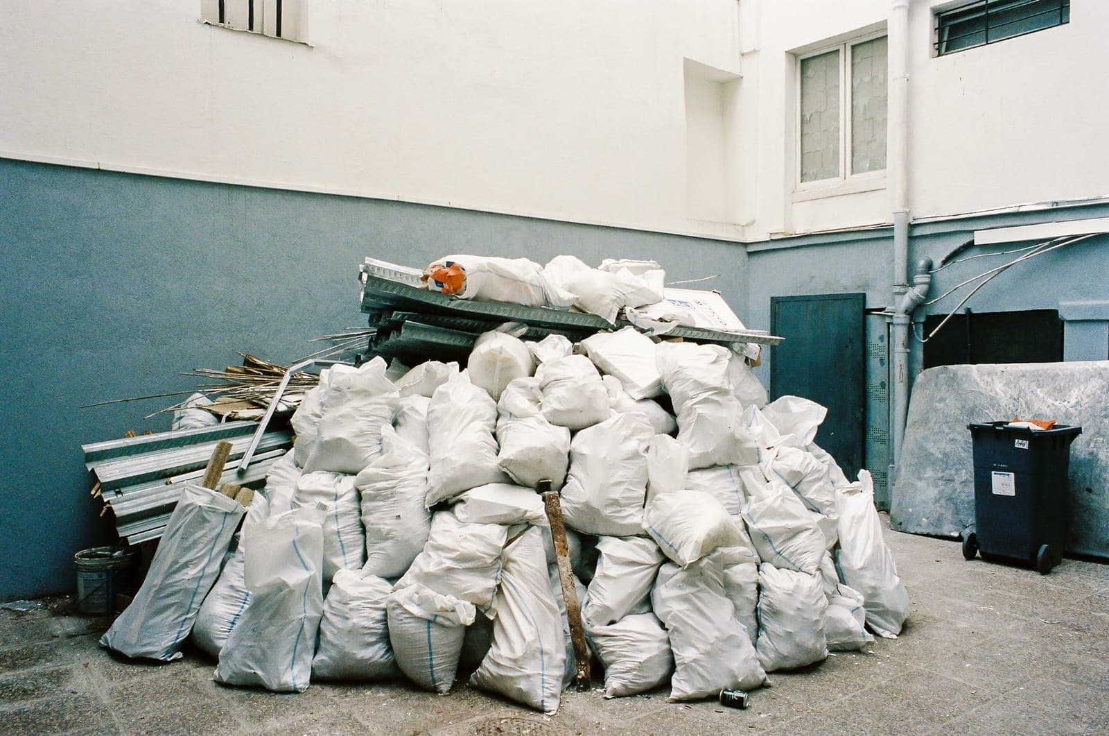 Sealed waste bags stacked and ready for collection