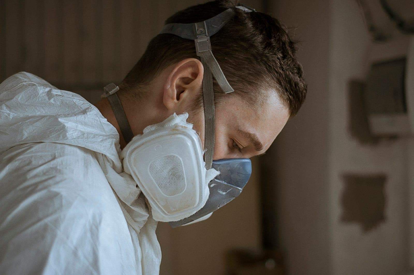 Worker in a protective suit and a filter respirator