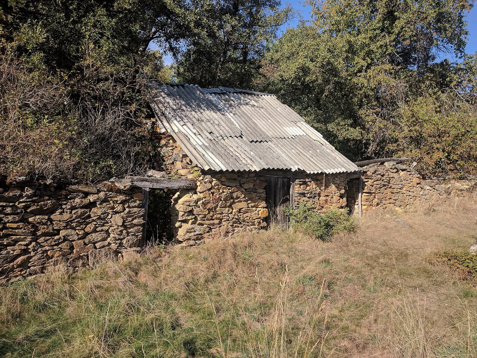 Old stone barn with a fibre-cement roof
