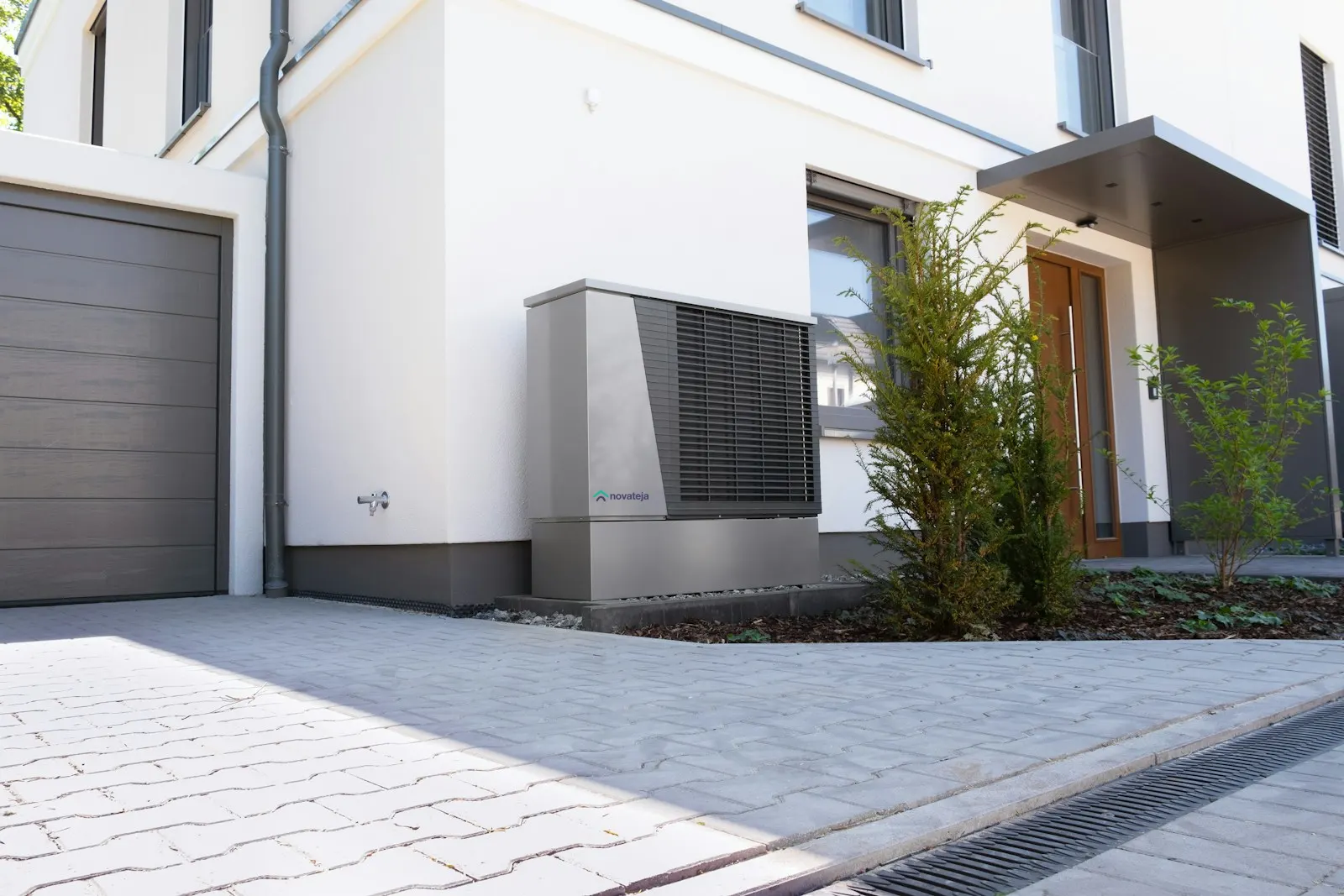 Heat-pump outdoor unit beside a modern house